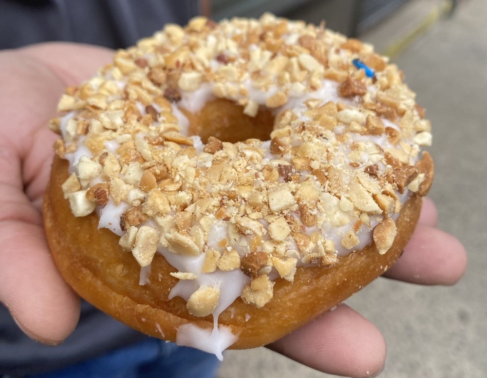 vanilla glazed donut with peanuts